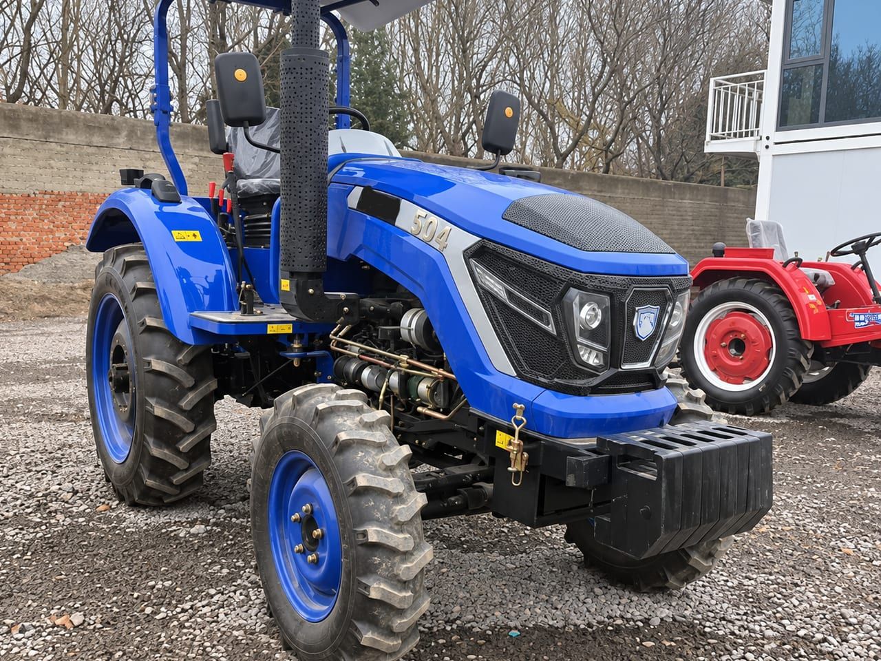 Agriculture Tractor 504 from the front right, showing the four-wheel-drive front axle and the front weight block