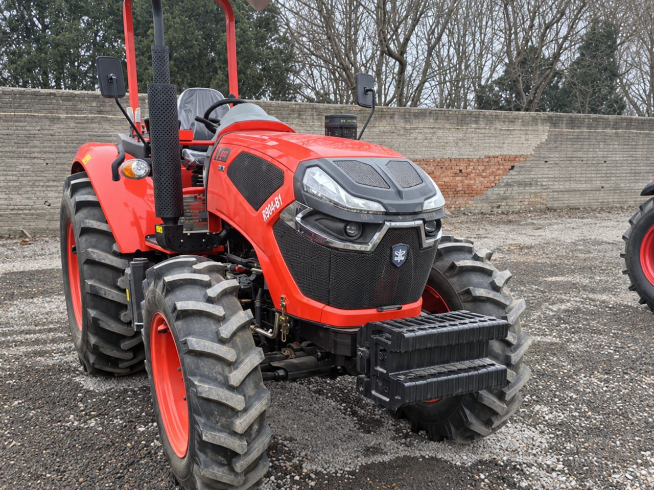 Agriculture Tractor 904 from the front, showing the four-wheel-drive front axle, the agricultural tyres and the front weight block
