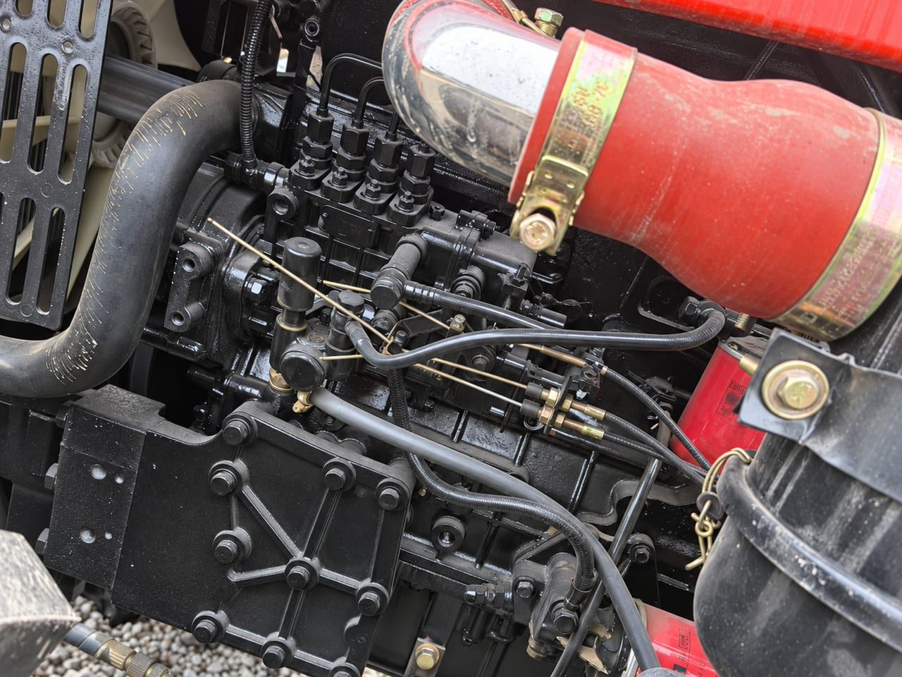 Agriculture Tractor 904 engine bay from the side: the injection pump and the air intake hose