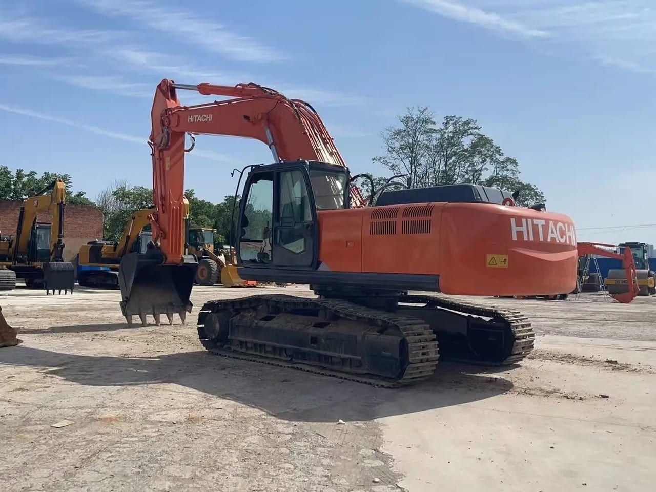 Hitachi ZX350-5G from the rear three-quarter, showing the counterweight, the cab and the tracks with the bucket resting ahead