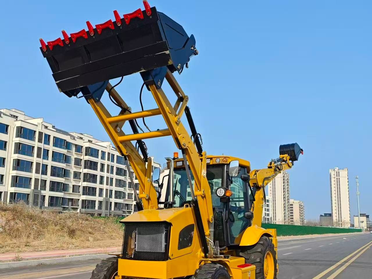 LJ3CX-A backhoe loader from the front with the loader bucket lifted to full height