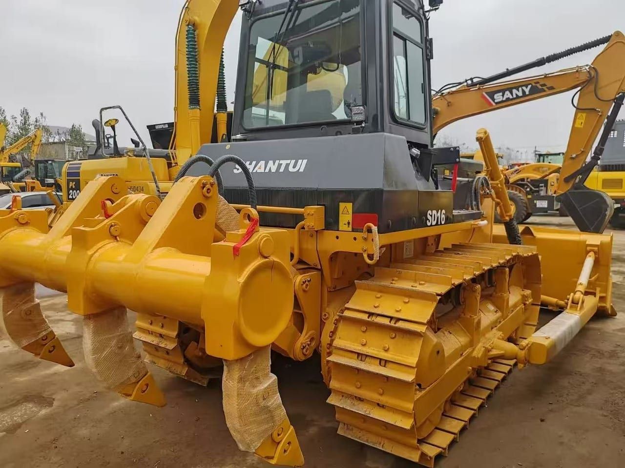 Shantui SD16 bulldozer from the rear three-quarter, the ripper shanks and the track frame