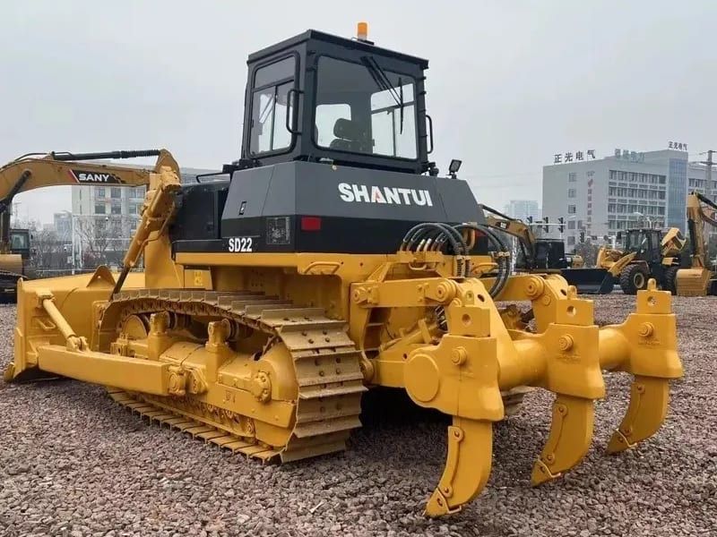 Shantui SD22 bulldozer rear three-quarter, showing the three-shank ripper and the length of the track