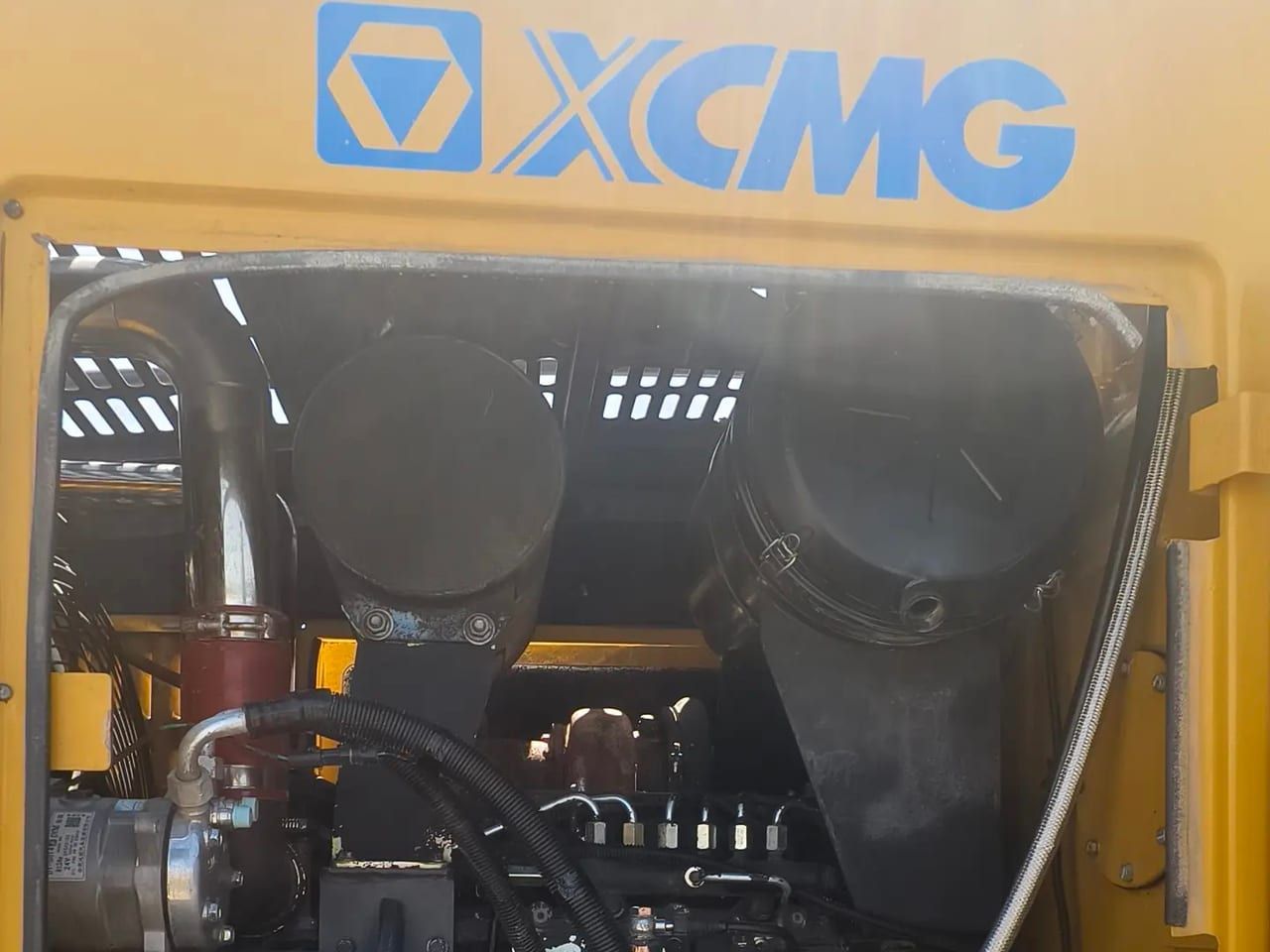 XCMG GR1803 engine compartment opened under the XCMG panel, showing the diesel engine