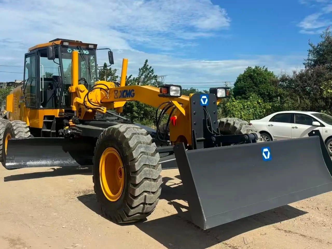 XCMG GR2153 motor grader from the front three-quarter, the front push blade lowered and the moldboard under the frame