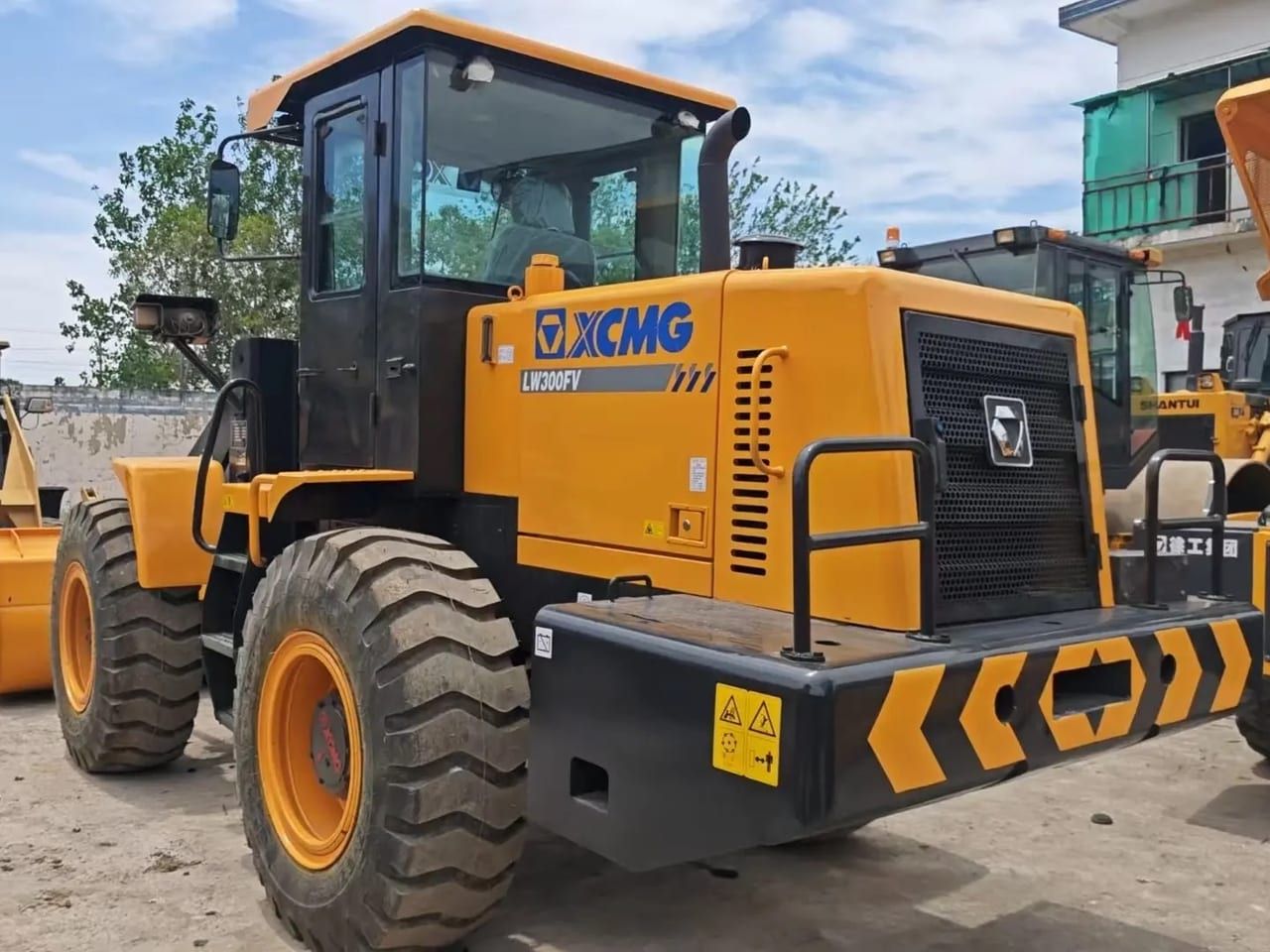 XCMG LW300FV wheel loader from the rear three-quarter on the other side, the chevron counterweight and the rear tyres